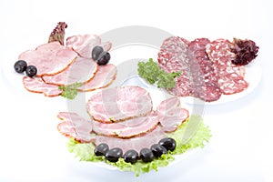 Cutting sausage and meat on a table.