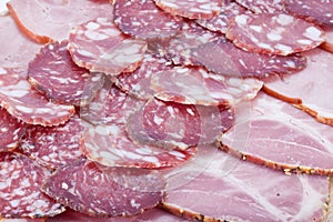 Cutting sausage and meat on a table.