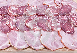 Cutting sausage and meat on a table.