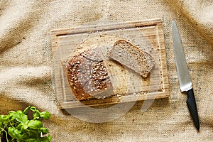 Cutting a slice of bread on wooden cutting board