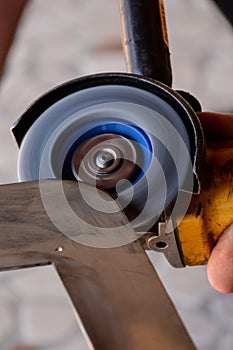 Cutting steel with angle grinder at car service