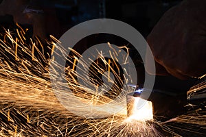 Cutting steel blanks with hand plasma, a large number of bright sparks, welding and metal processing