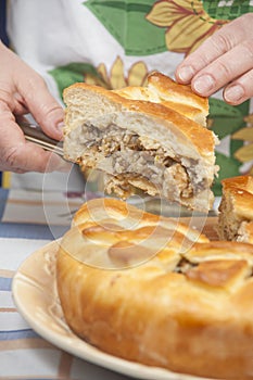 Cutting the tasty pie with filling