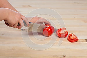 Cutting tomatoes for dishes on the table. Vegetables during the cooking process dishes. Vegetables for healthy eating