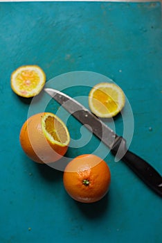 The cutting two oranges with knife in the blurred background