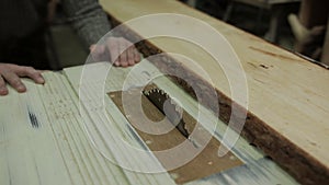 Cutting Wood in Carpenter workshop with Table Circular Saw.