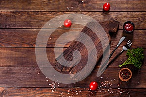 Cutting wooden board as well as vegetables and a special dark table