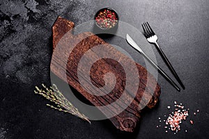 Cutting wooden board as well as vegetables and a special dark table