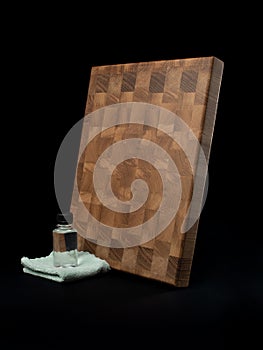 Square cutting wooden board, black background. Items for the kitchen.