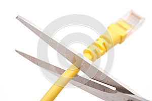 Cutting a yellow network cable with scissors