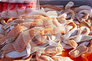 Cuttings of the bellies of red fish on the counter. A traditional delicacy of northern cuisine. Close-up