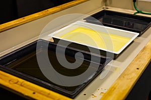 Cuvettes with solutions of photoprojector for analog photo printing. Classic photo lab darkroom