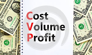 CVP cost volume profit symbol. Concept words CVP cost volume profit on white note on a beautiful background from dollar bills.