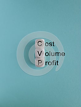 CVP cost volume profit symbol. Concept words CVP cost volume profit on wooden cubes on a beautiful blue background.