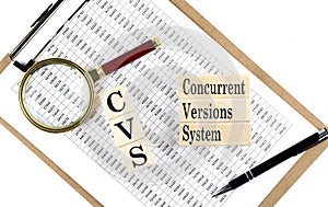 CVS - Concurrent Versions System text on wooden block on chart background photo