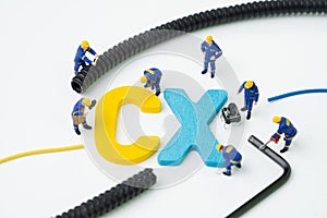 CX, Customer Experience concept, miniature figure worker building alphabet CX at the center, important of customer centric