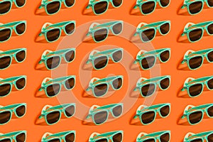 Cyan, aqua menthe sunglasses pattern isolated on background of lush lava color.