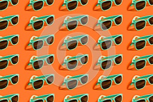 Cyan, aqua menthe sunglasses pattern isolated on background of lush lava color. photo