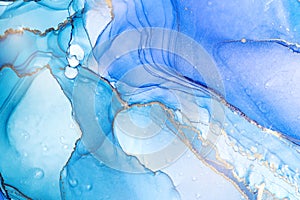 Cyan blue liquid watercolor background with golden stains. Teal turquoise and violet marble alcohol ink drawing effect