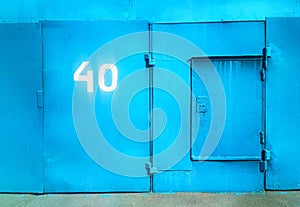 Cyan closed garage door with numer 40 city background