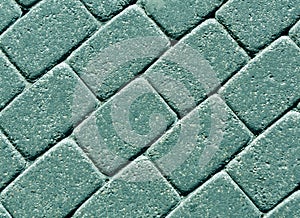 Cyan color cobblestone pavement surface.