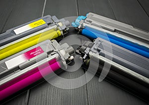 Cyan, magenta, amariyllo and black color toner rollers of a foreground color laser printer