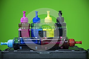 Cyan, magenta, yellow and black Ink jet refill colors in bottles. Colors used in color printer