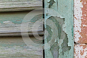 Cyan peeling paint window wood planks and pink brick wall