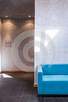 Cyan sofa in industrial interior