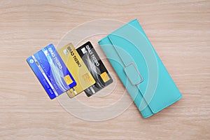 Cyan wallet and credit cards on wood table background
