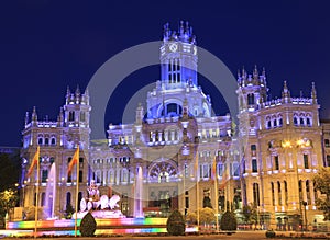 Cybele Palace and fountain illuminated at night in Madrid, Spain photo