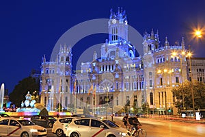 Cybele Palace and fountain illuminated at night in Madrid, Spain photo