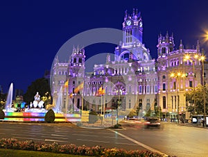 The Cybele Palace and fountain illuminated at night in Madrid, Spain photo