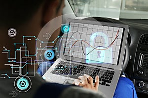 Cyber attack protection. Man using laptop in car. Scheme and lock illustration