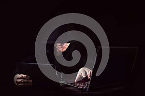 Cyber attack with unrecognizable hooded hacker