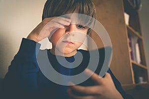 Cyber bullying concept - depressed boy with phone and negative comments