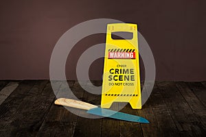 Cyber crime scene do not cross with knife on table top