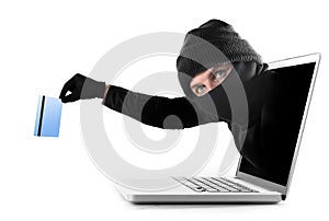 Cyber criminal out of computer grabbing and stealing credit card cyber crime concept