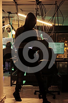 Cyber criminals team hacking computer system, coding malicious software