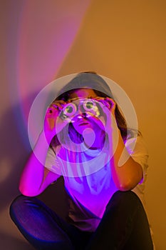 Cyber figure with virtual reality glasses. Beautiful slim person immersed in a digital environment surrounded by neon shining