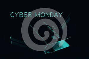 Cyber monday sale concept. Credit card on mobile phone with neon blue colour text close up on Black monochromatic background