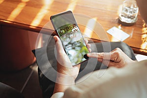 Cyber Monday Sale Concept, Senior woman hand holding smartphone for online shopping