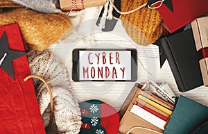 Cyber Monday sale text sign on phone screen, flat lay. Special d