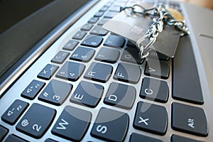 Cyber Security With Chain & Lock Around Credit Card On Laptop Keyboard