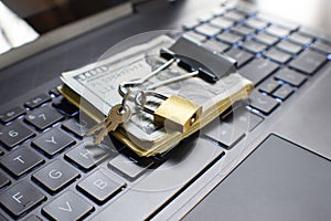 Cyber Security Concept With Small Gold Key Lock On Money Protecting It From Online Hackers And Scammers