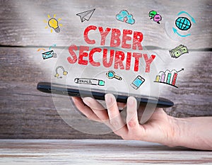 Cyber Security concept. Tablet computer in the hand. Old wooden background