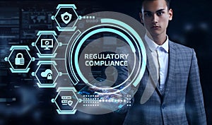 Cyber security data protection business technology privacy concept. Young businessman select the word REGULATORY COMPLIANCE on the