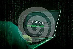 Hacker initiating file-transfer with binary code background.
