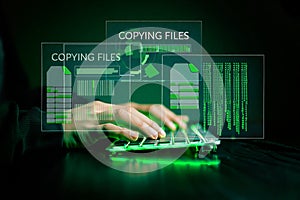 Hacker initiating file-transfer with binary code background.