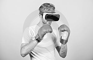 Cyber sportsman boxing gloves. Man play game in VR glasses. Cyber sport concept. Man boxer virtual reality headset